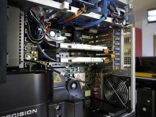 Technician working on network servers with a tablet in a data center